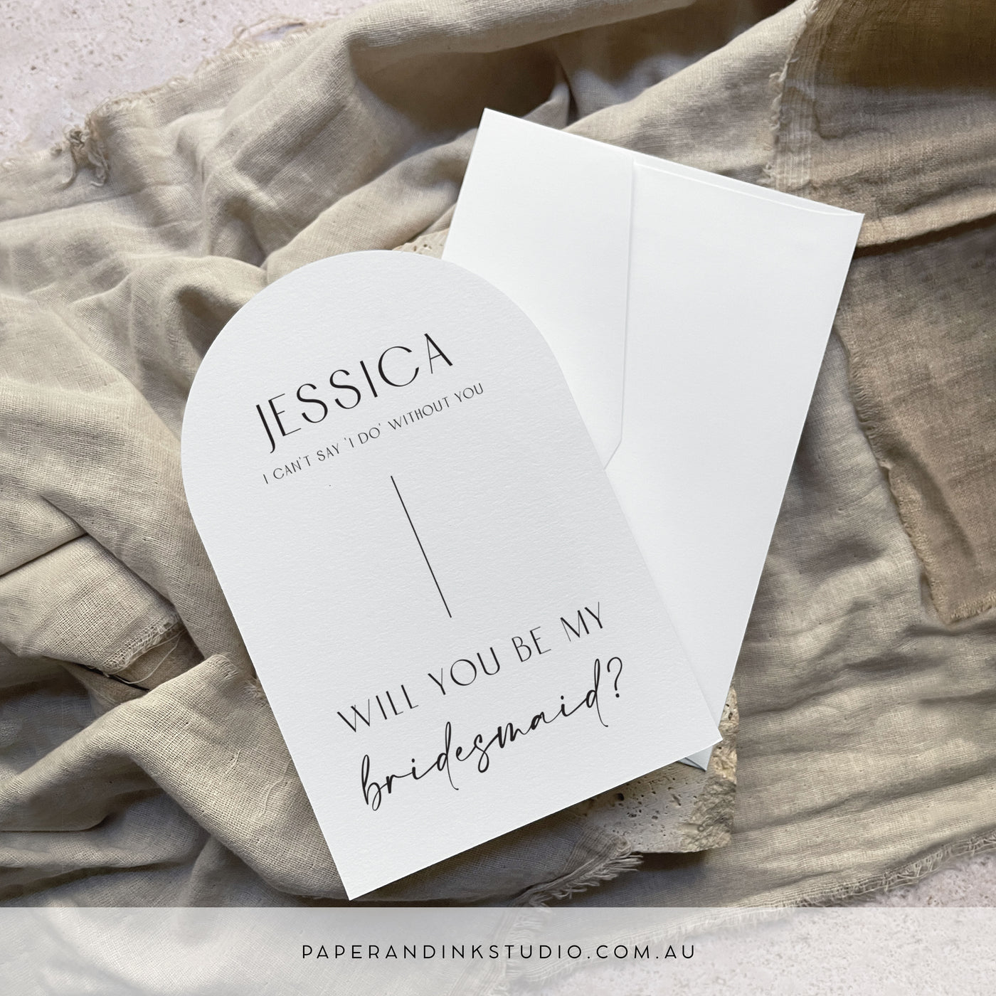 A flat white arch shaped card that can be personalised with the receiver's name, to thank them for being a part of of the couple's wedding party. This one says will you be my bridesmaid.
