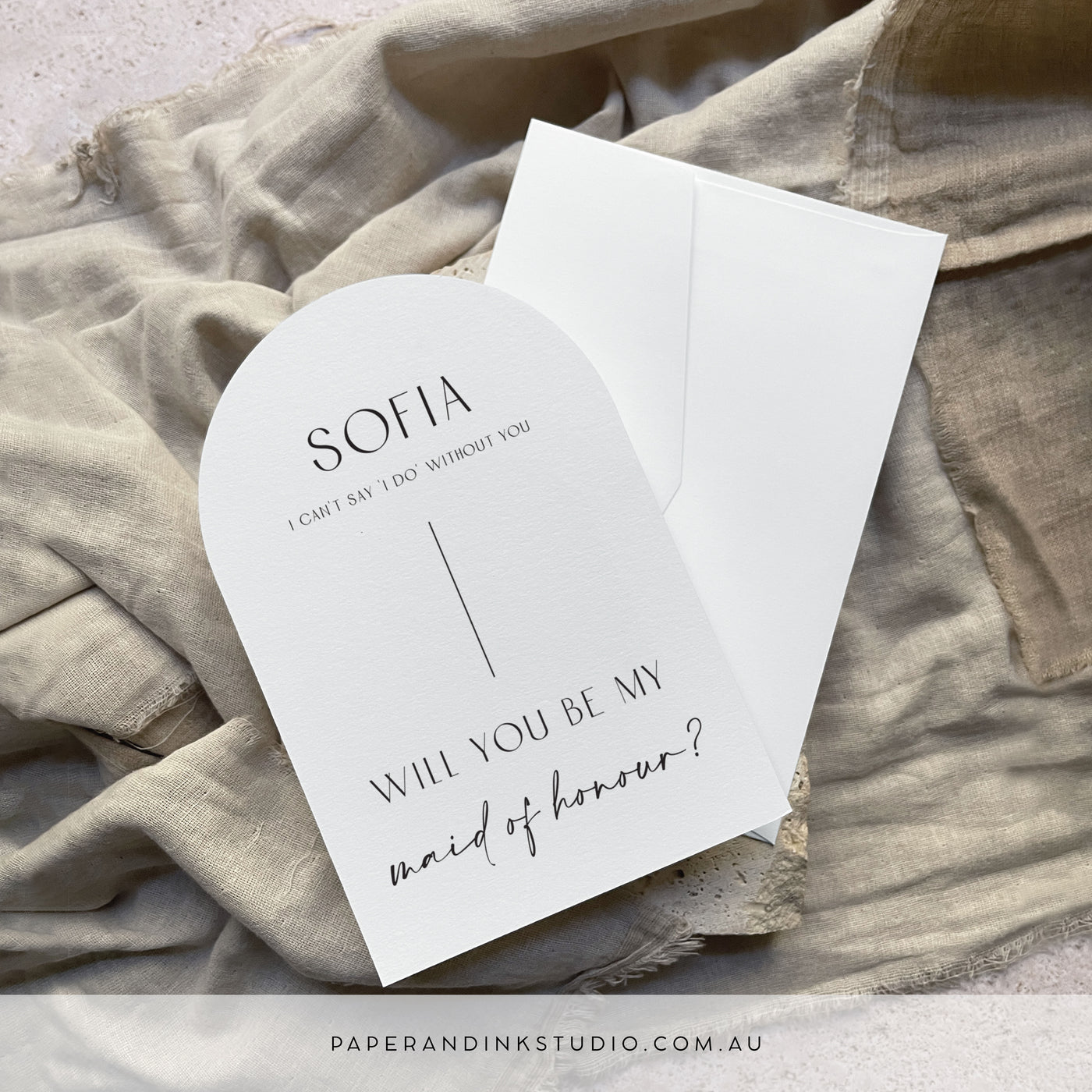 A flat white arch shaped card that can be personalised with the receiver's name, to thank them for being a part of of the couple's wedding party. This one says will you be my maid of honour.