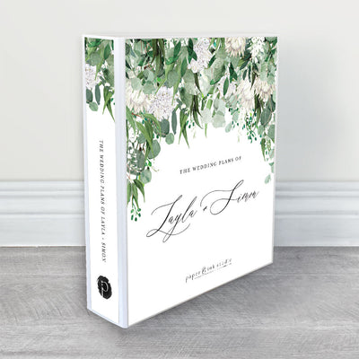 A wedding planner, guide and organiser in a rustic floral wedding theme with white proteas, white wisteria and white chrysanthemum flowers and dark green eucalyptus and gum leaves and black calligraphy