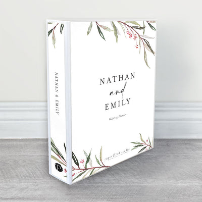 A wedding planner, guide and organiser in a rustic wedding theme with watercolour gum leaves and tiny red berries with black writing on a white background