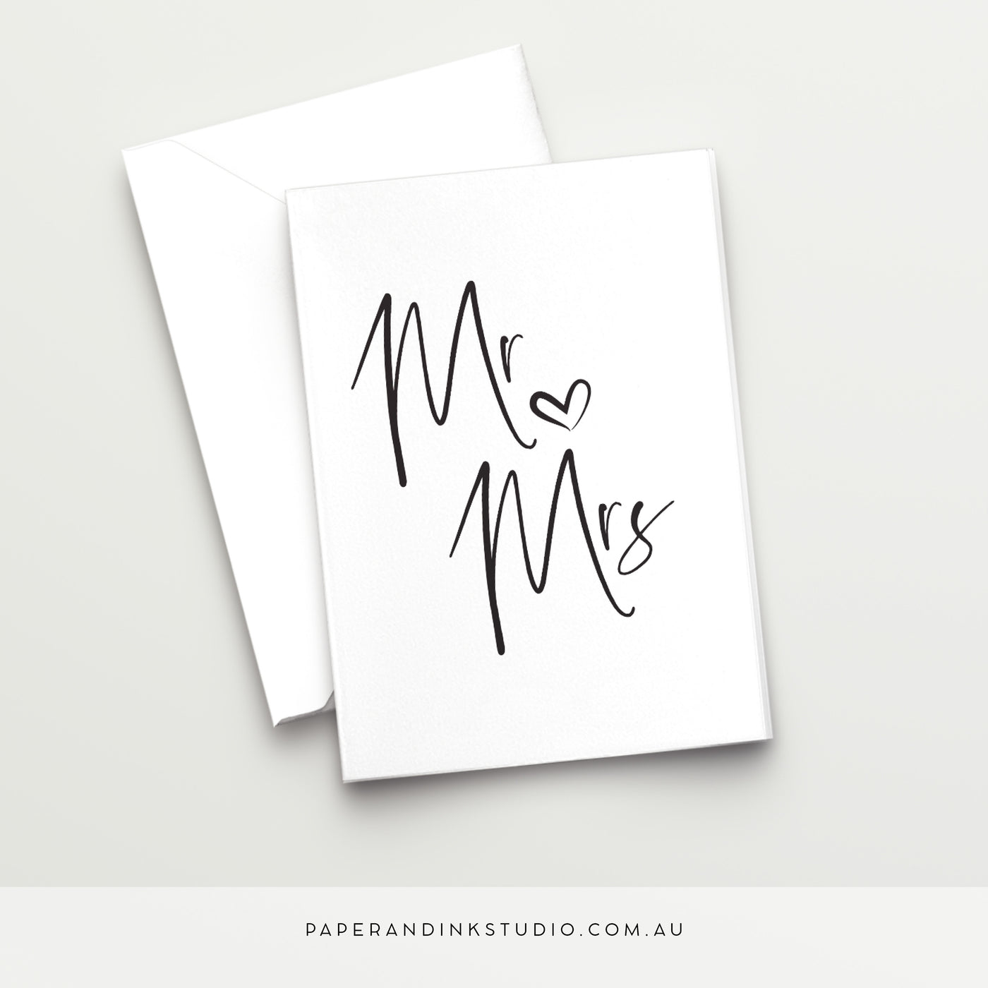 A white folded wedding card in a design called Thorne with black writing that says Mr and Mrs with a love heart between, in a beautiful handwritten font, to give to the bridal couple as a wedding card on their wedding day