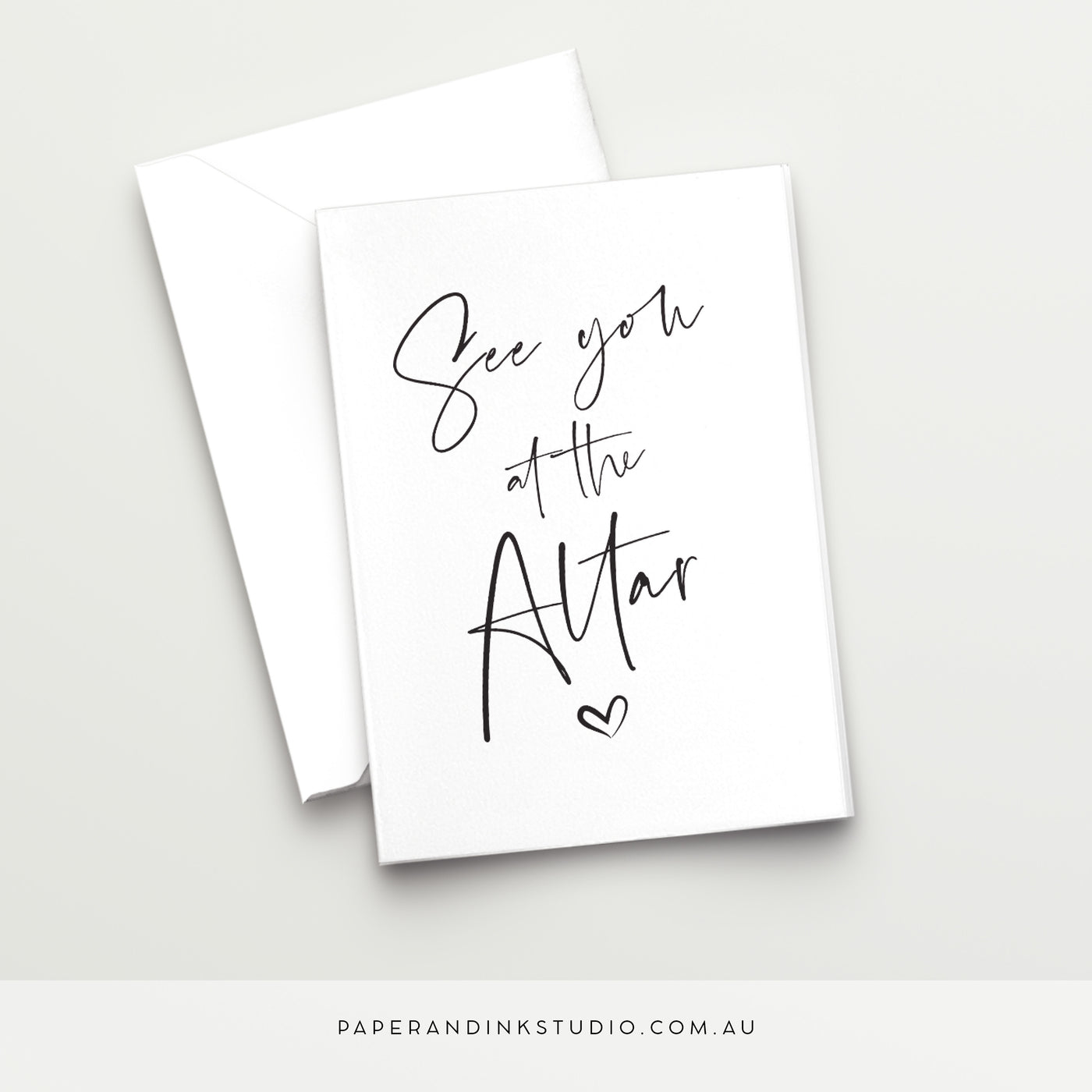 A white folded wedding card in a design called Thorne with black writing that says See You at the Altar with a love heart below it, in a beautiful handwritten font, to give to the bride or groom as a wedding card on their wedding day.